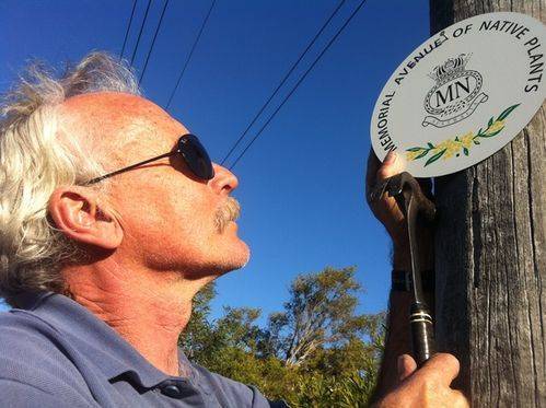 Volunteer Keith Burn affixing a memorial plaque